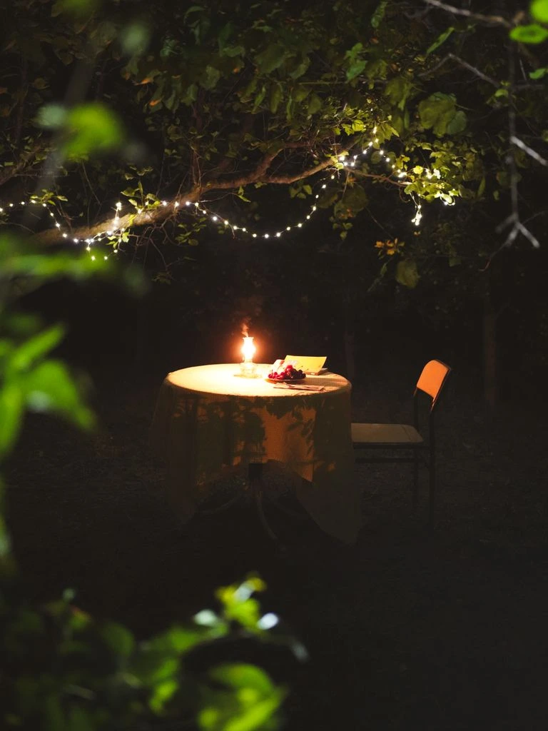 Candlelit table set for eight inside the 1903 wine cave at Fanal Racou